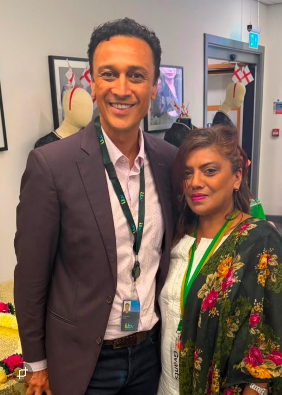 Two colleagues at an ITV Leeds event, one wearing an ITV lanyard and the other in a floral traditional shawl.